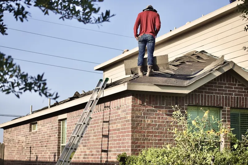 Professional roofer working on a residential roof in Desert Peak